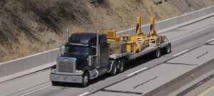 truck with large bed hauls big equipment pieces on highway Worldwide Sourcing & Solutions United States, China