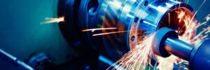 large manufacturing machine cuts parts with sparks flying Worldwide Sourcing & Solutions United States, China
